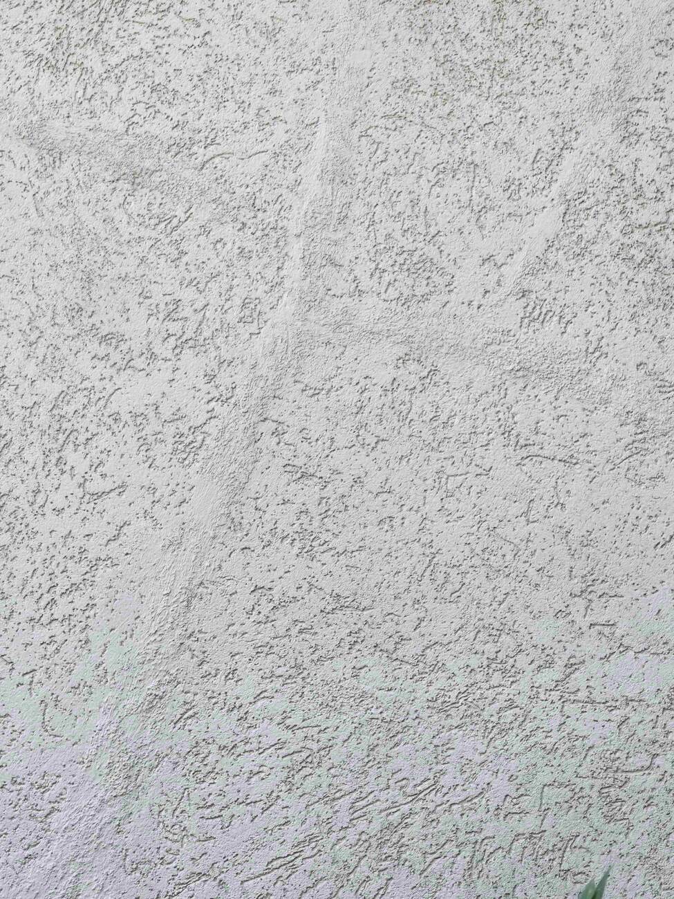 Stucco dash knockdown texture close-up that a repair must match so paint lays uniformly