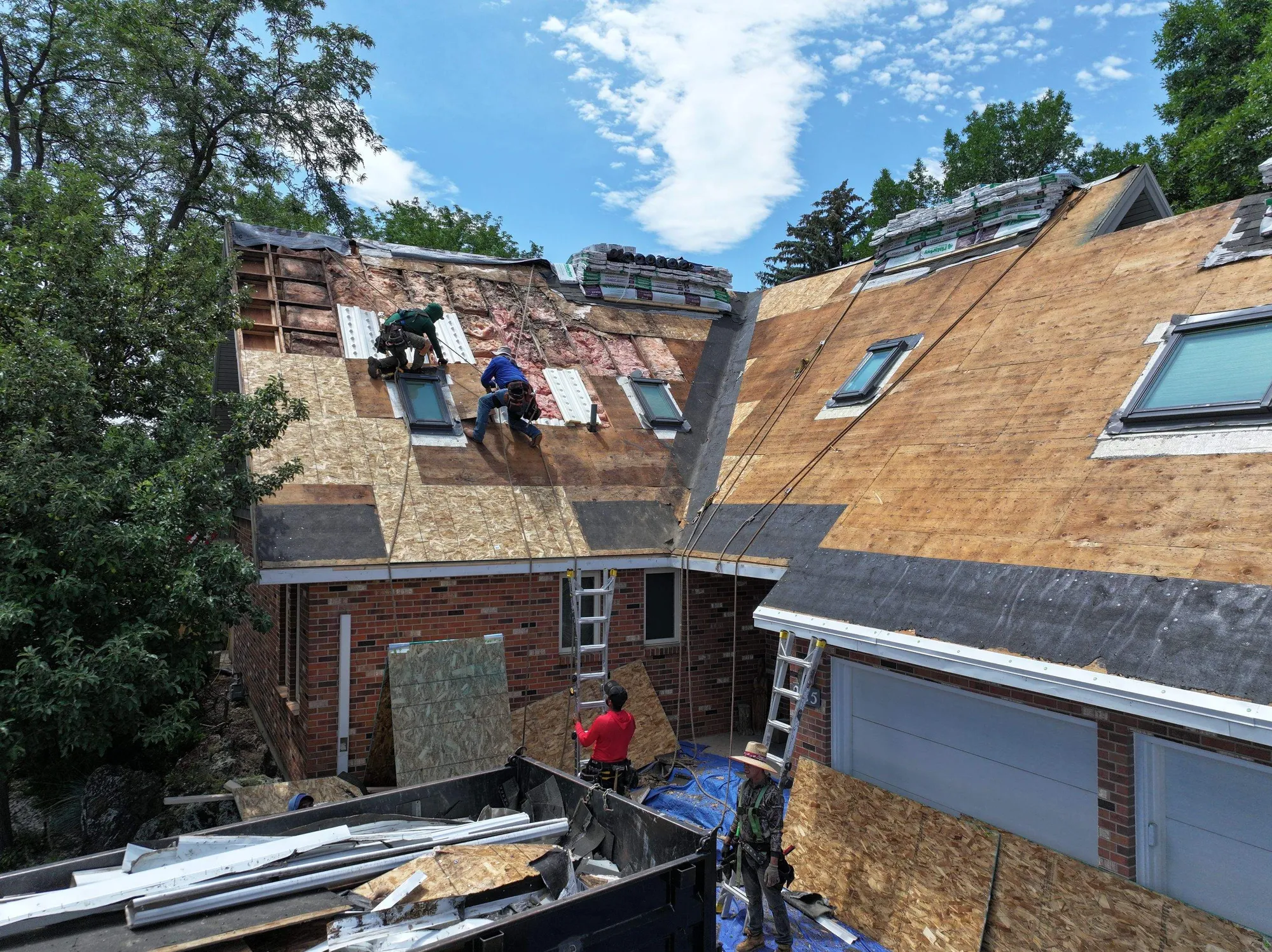 Before — storm-damaged roof mid tear-off, Colorado